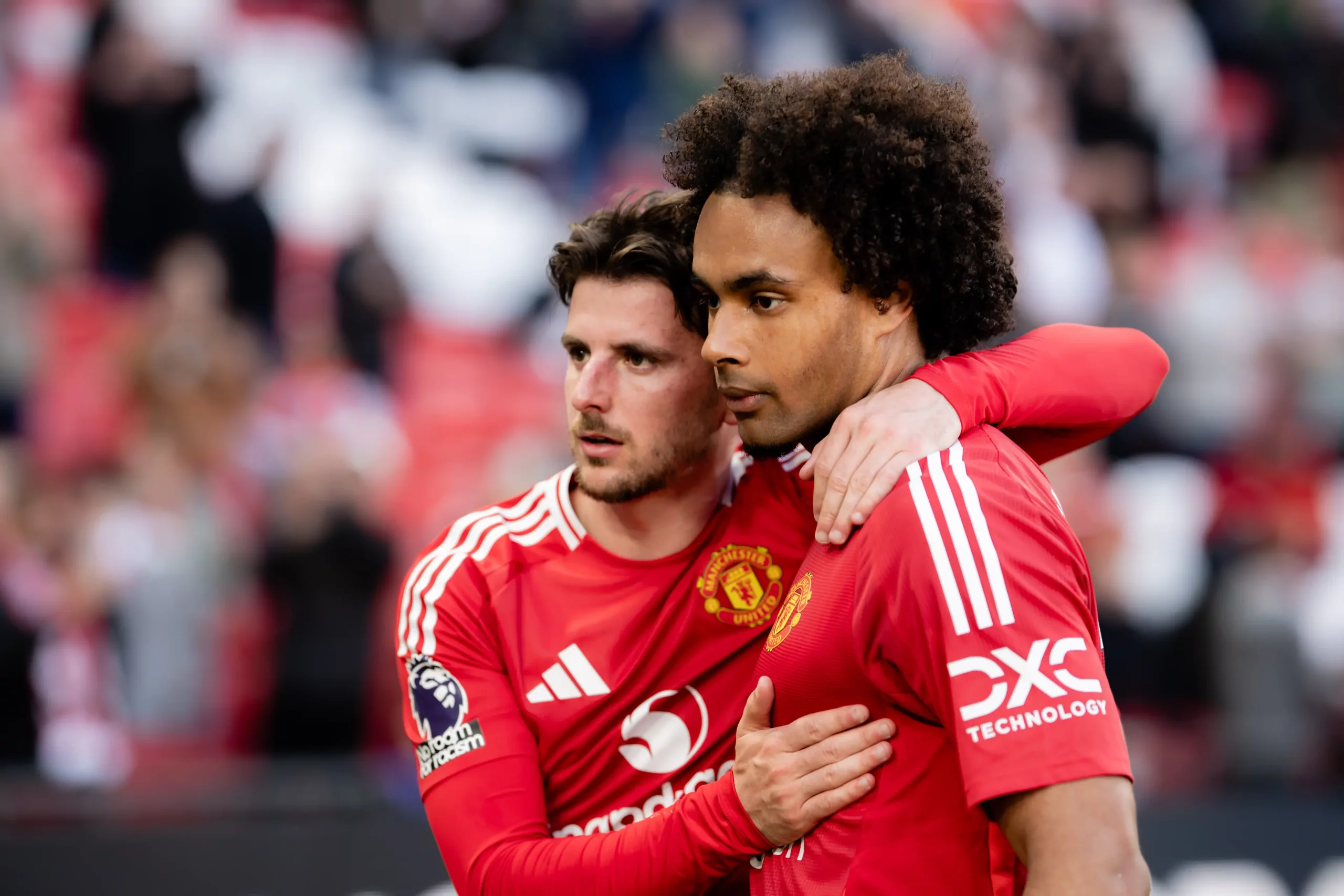Mason Mount of Manchester United reacts with Joshua Zirkzee at the end of the Premier League match between Manchester United FC and Manchester City FC scaled